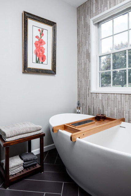 spa-like bathroom remodel. Soaking tub next to window, earthy tones in room.